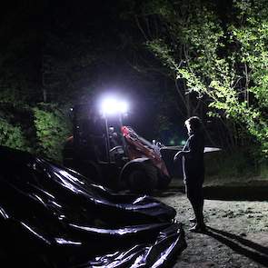 Als hulp Gijs met een shoveltje voor de nacht wat zand op het plastic heeft gedeponeerd, kan de melkveehouder proosten op de goede afloop.